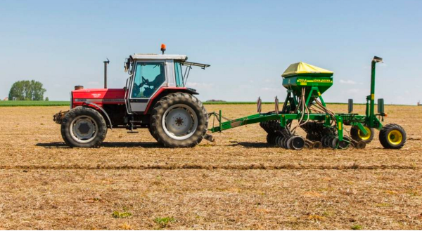 Red Tractor Pulling Green Combine